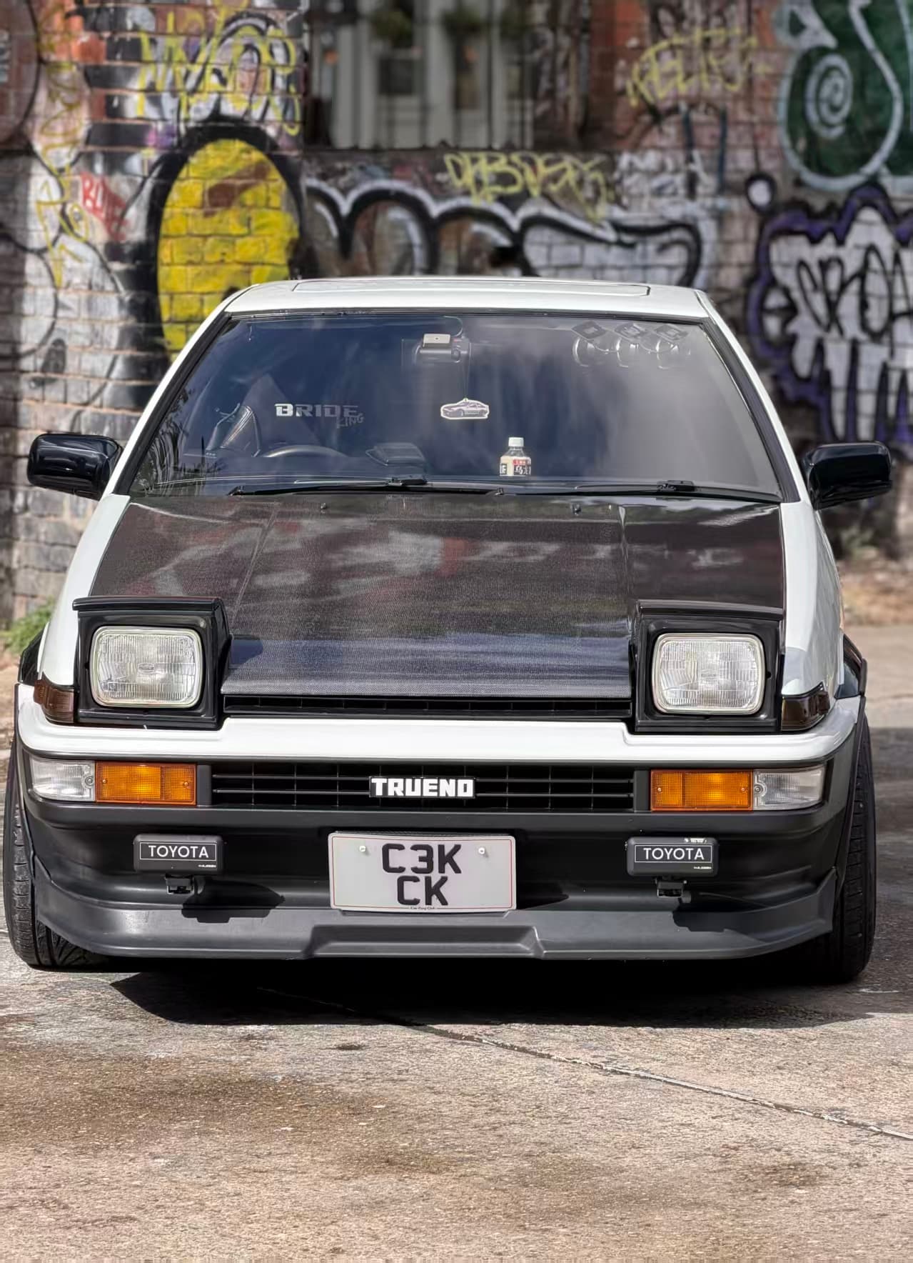 Actual motorized pop-up auxiliary lights mounted at the front of a custom car