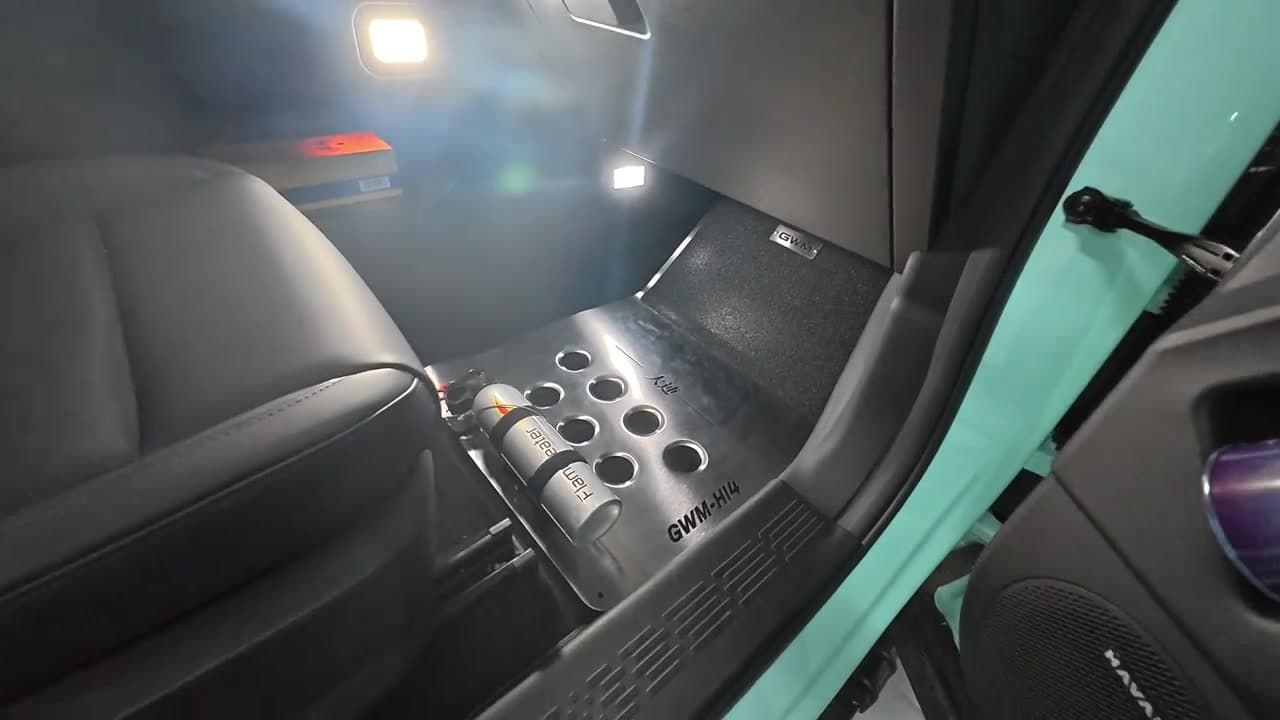 Brushed stainless steel floor mat fitted inside an everyday SUV