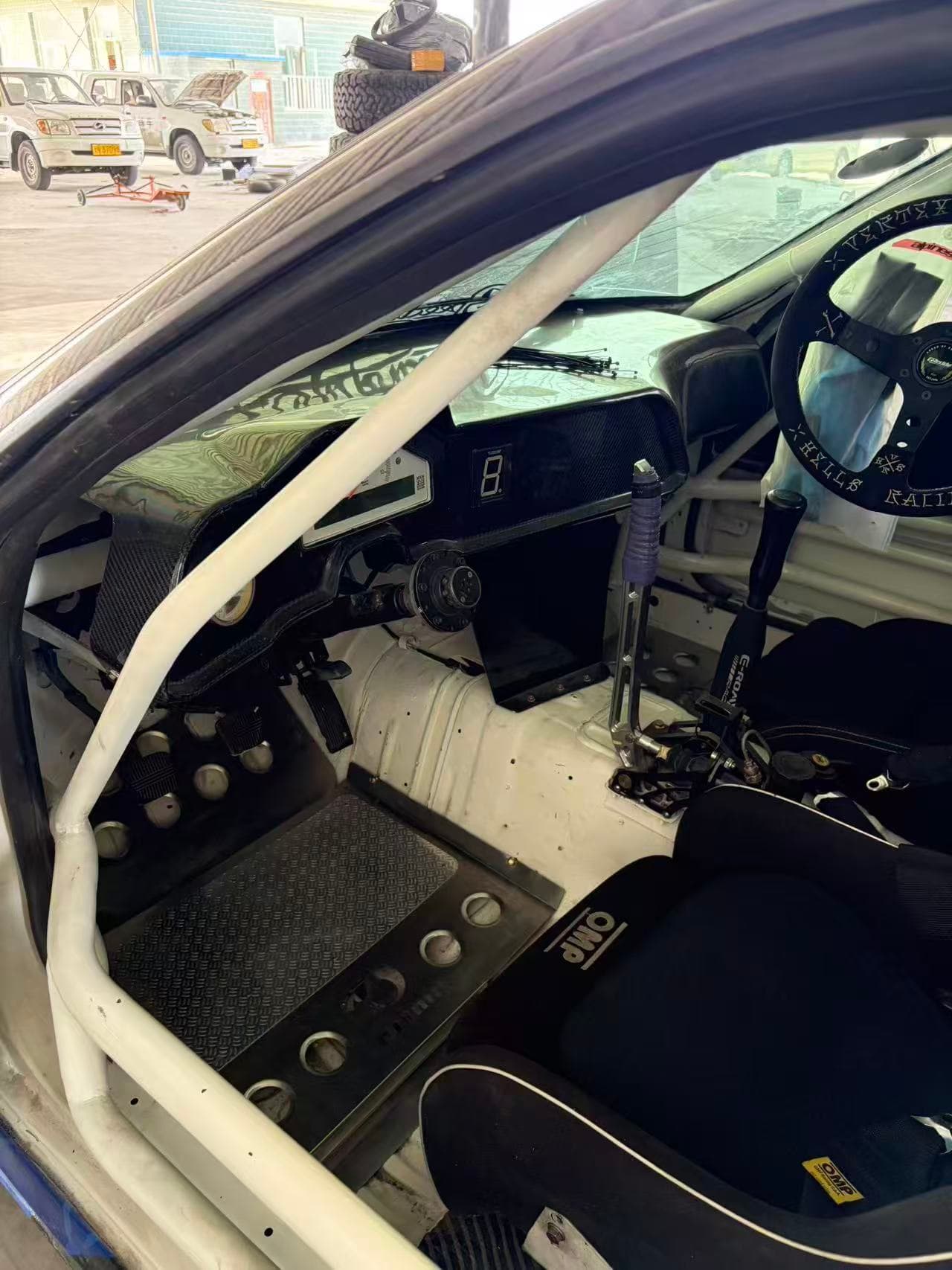 Vehicle-specific formed metal floor panel fitted in a custom car interior