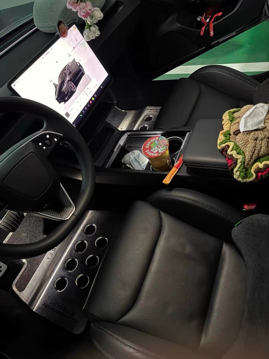 Real daily-use car interior fitted with custom brushed stainless steel floor mats