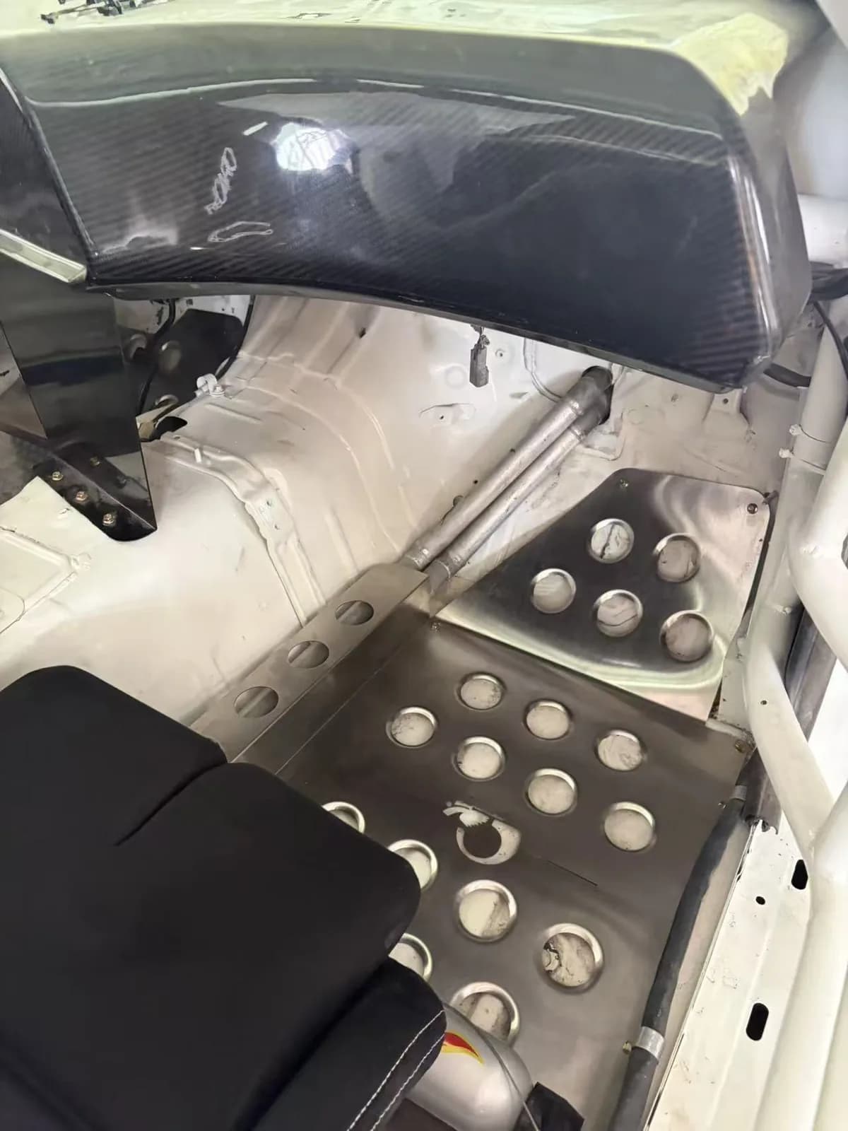 Actual metal floor panel detail in a competition-style vehicle cabin