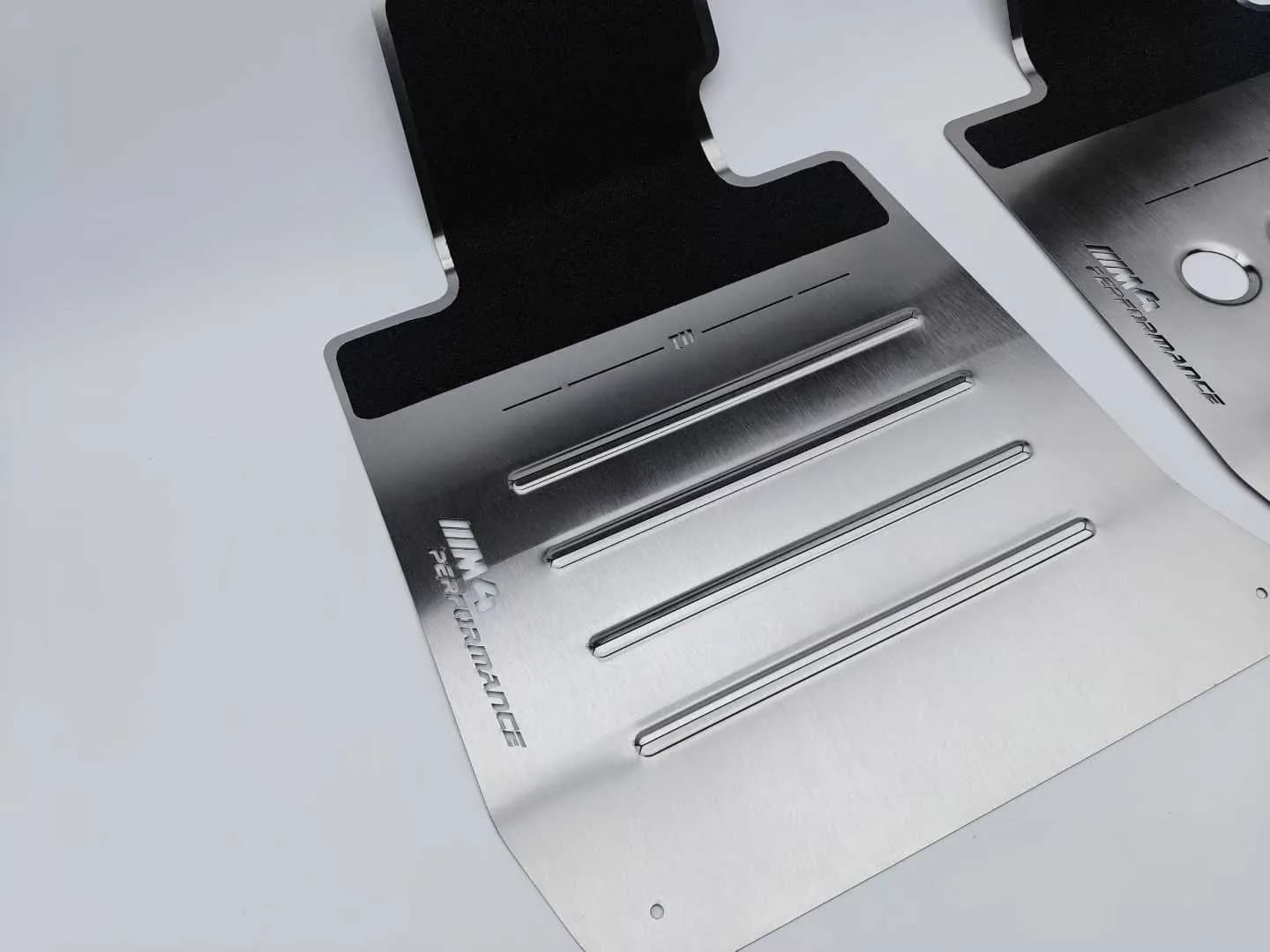 Studio view of an actual ribbed brushed metal floor mat front pair