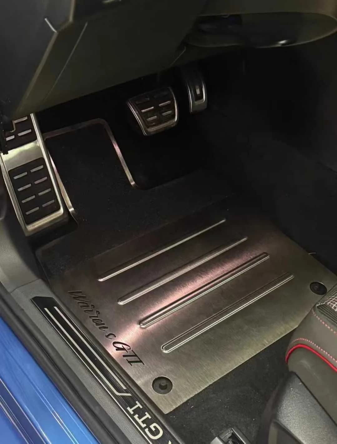 Actual ribbed brushed metal floor mat installed in a modern vehicle cabin