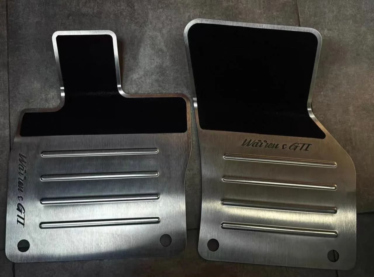 Actual ribbed brushed metal floor mat pair with black contact panels