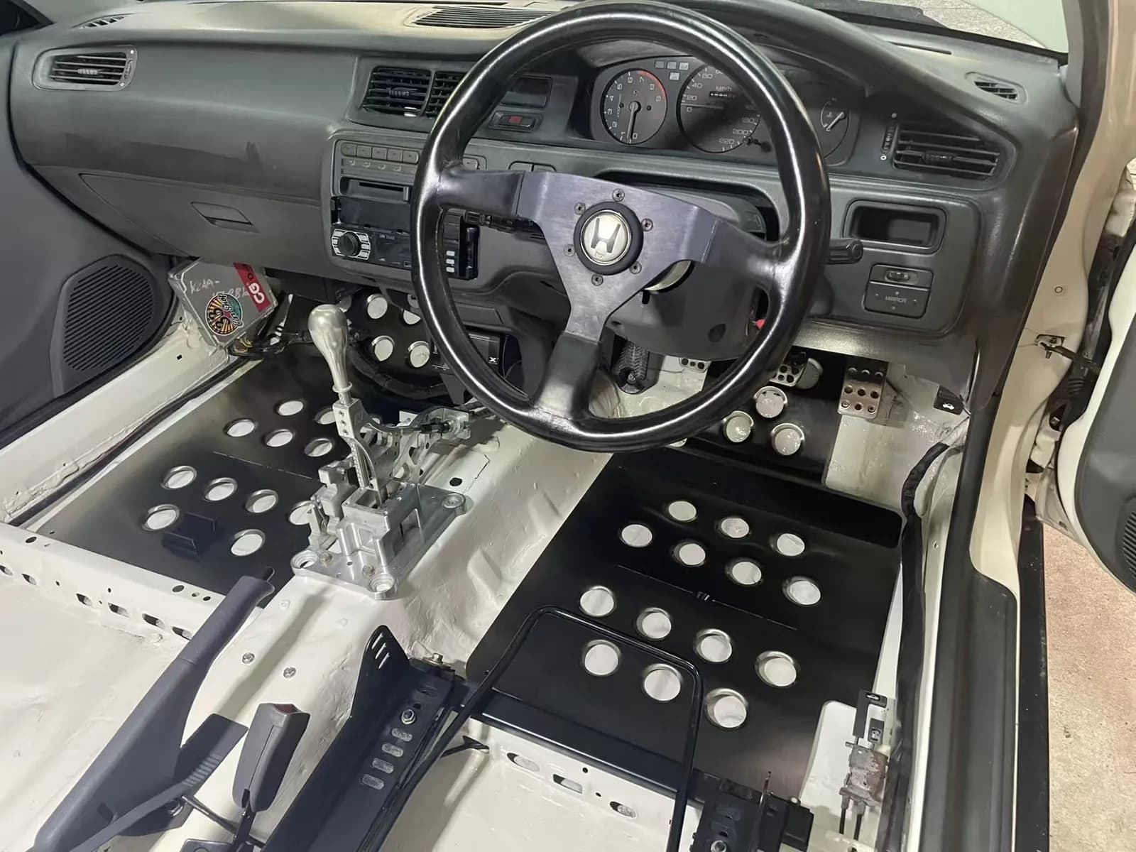 Actual perforated metal floor system in a stripped specialist vehicle cabin