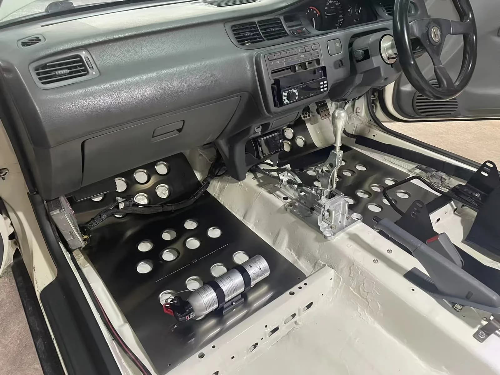 Actual wide metal floor panel installation in a specialist vehicle cabin