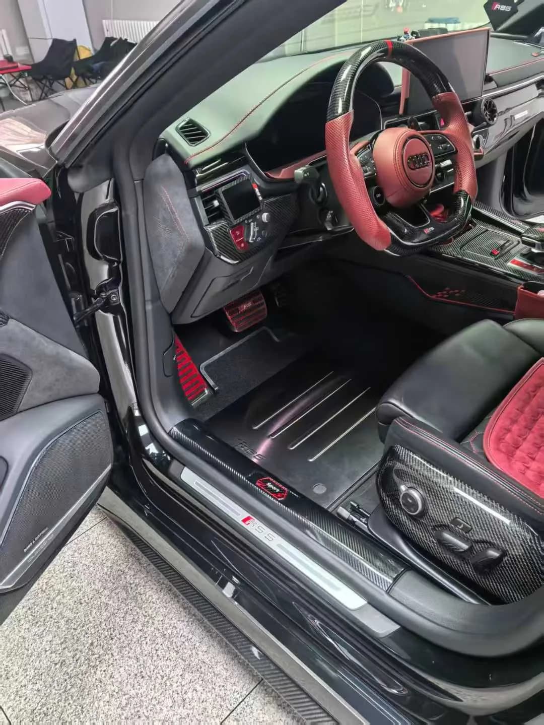 Actual custom metal driver floor mat installed in a black and red sport cabin