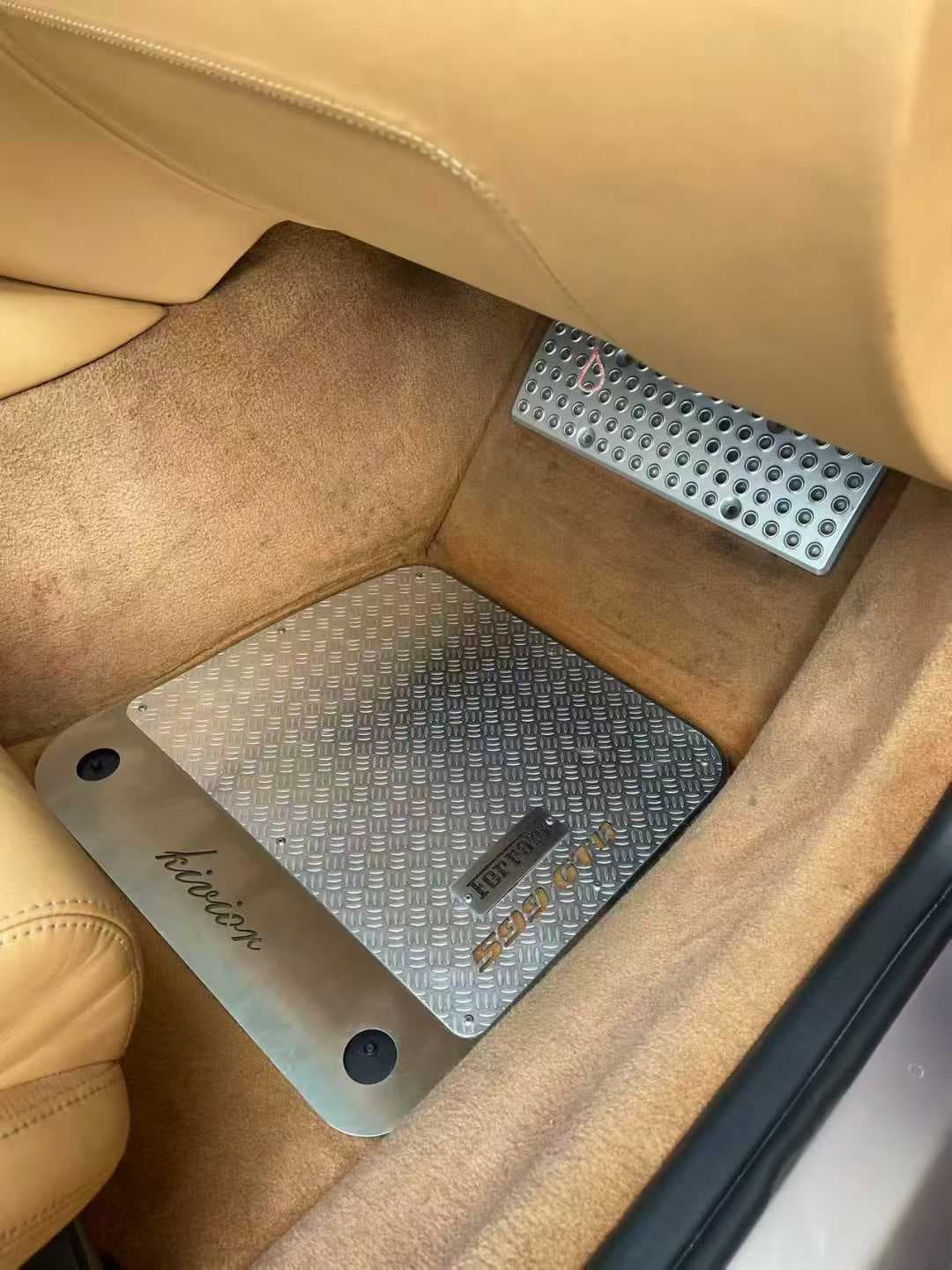 Actual brushed metal floor mat installed in a tan everyday-car interior